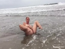 Juego de coño en la playa pública en el océano Pacífico