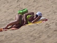 Señora con bikini amarillo en la playa de lado