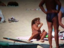 Mujer morena desnuda cachonda provocando a sus compañeros en la playa