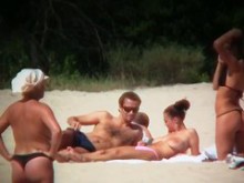 Enormes damas sexy boobed se acuestan en la playa y se relajan
