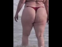 Rubia culona jugando en la playa