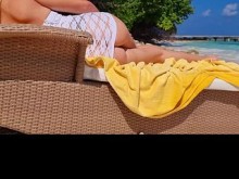 Milf relajándose en la playa y masturbándose